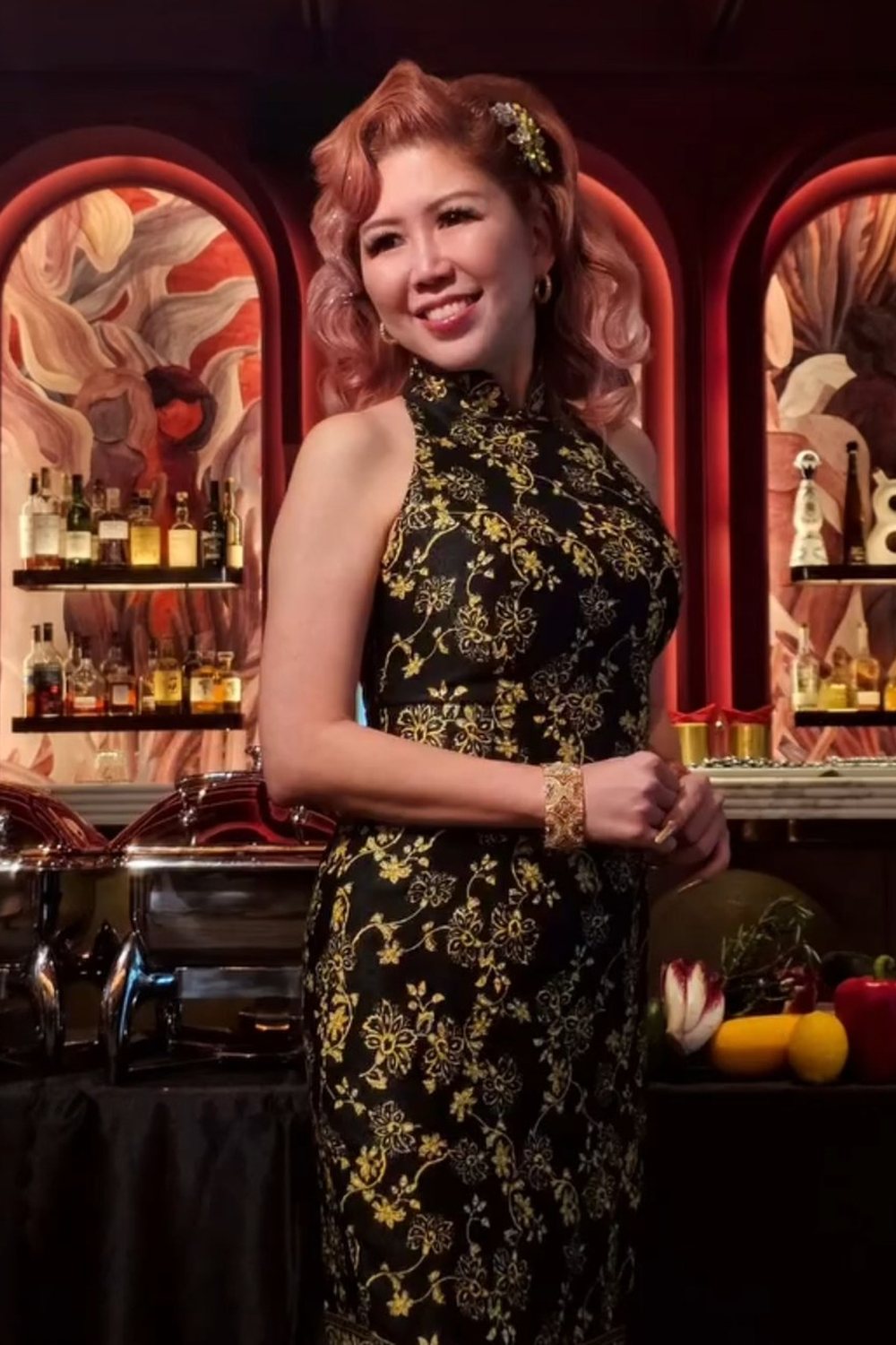 Celestia Faith Chong in a black and gold cheongsam.